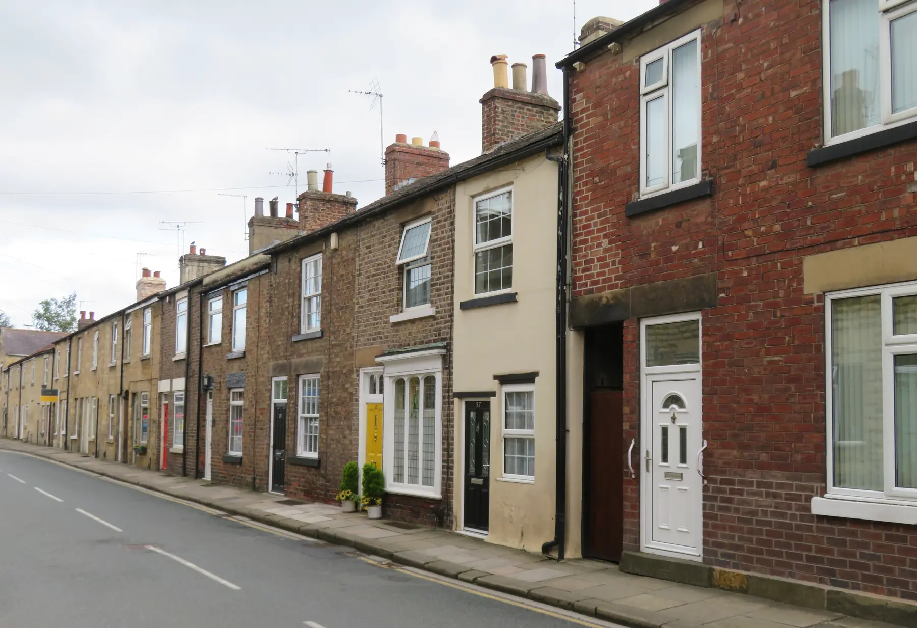 A red-brick terrace with painted front doors