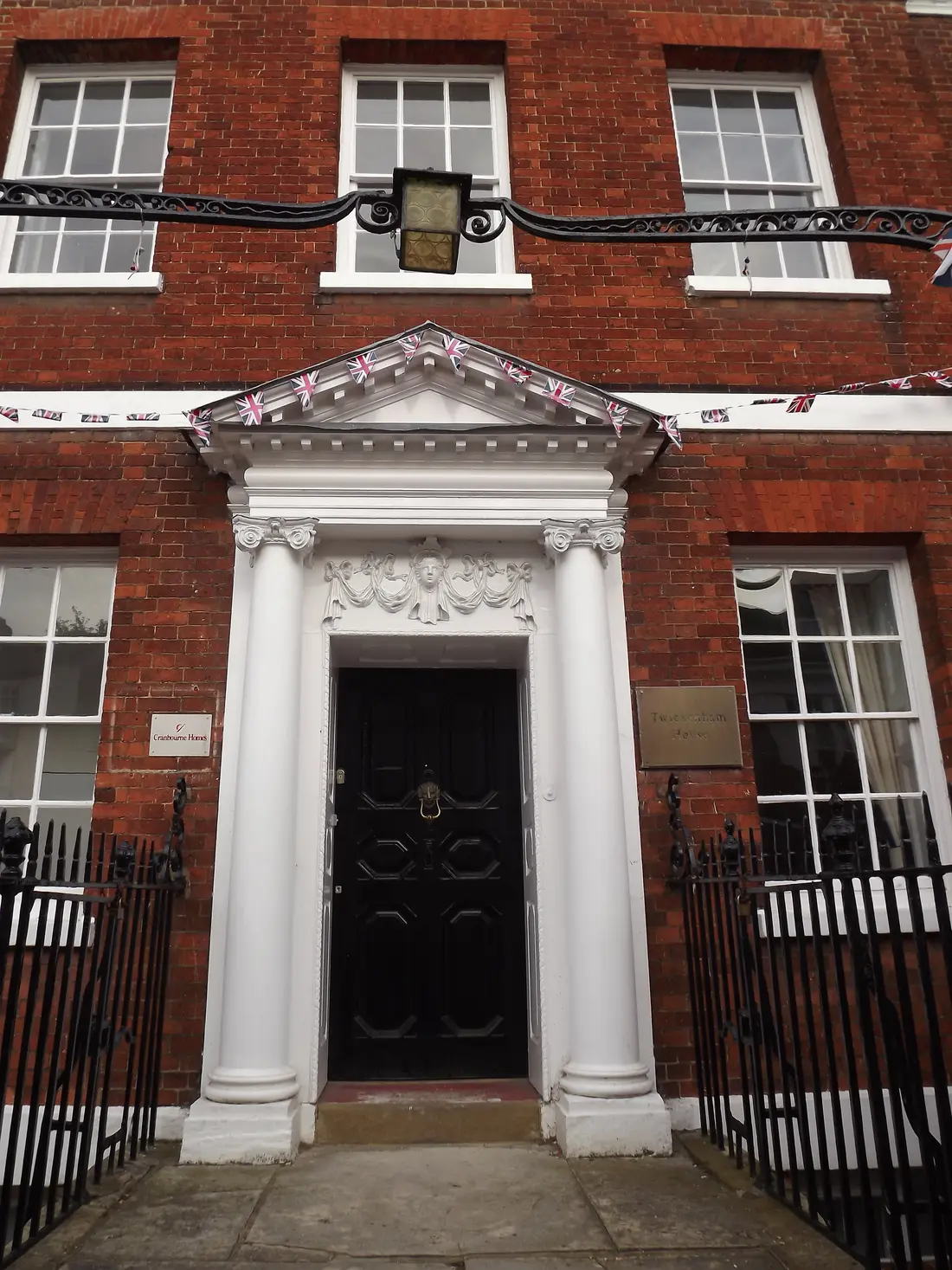 A Georgian doorway with columns and a black front door in Abingdon